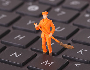 Image showing Miniature worker is cleaning a keyboard