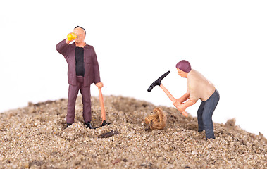 Image showing Miniature workers with pickaxes