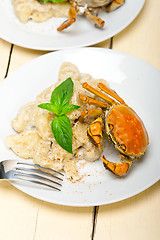 Image showing Italian gnocchi with seafood sauce with crab and basil