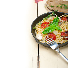 Image showing spaghetti pasta with baked cherry tomatoes and basil 