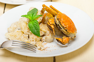 Image showing Italian gnocchi with seafood sauce with crab and basil