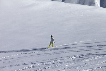 Image showing Snowboarder downhill on off piste slope with newly-fallen snow