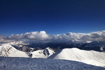 Image showing Off-piste slope and beautiful snowy mountains in evening