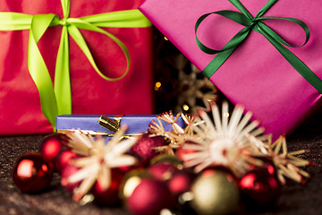 Image showing Ribbons, gifts, baubles and straw stars
