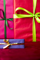 Image showing Green bowknots on red gift wrapping
