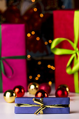 Image showing Baubles, twinkles and three wrapped gifts
