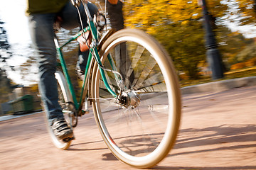 Image showing Man with bicycle riding country road