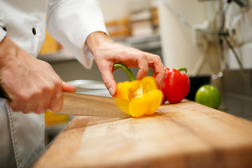 Image showing man's hands cutting pepper. Salad preparation