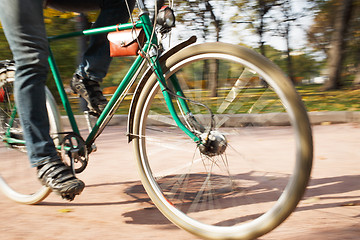 Image showing Close-up of young man riding bicycle in park