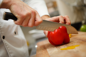 Image showing man's hands cutting pepper. Salad preparation