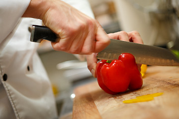 Image showing man's hands cutting pepper. Salad preparation