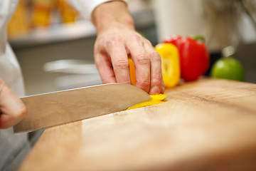 Image showing man's hands cutting pepper. Salad preparation