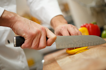 Image showing man's hands cutting pepper. Salad preparation