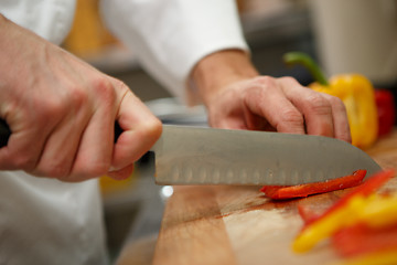 Image showing closeup on hands cutting yellow pepper