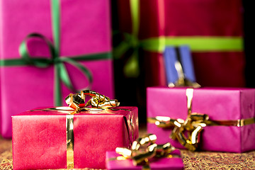 Image showing Red Gift Parcel amidst other Presents