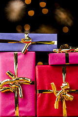 Image showing Four Single-Colored Gifts with Golden Bows