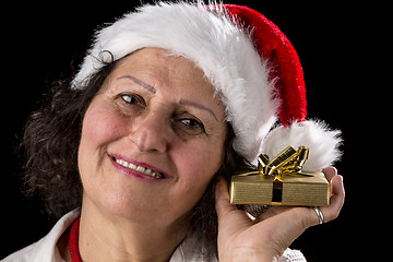 Image showing Middle-Aged Woman Holding Golden Gift