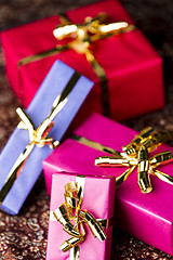 Image showing Four Wrapped Gifts with Golden Bows
