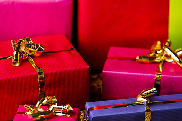 Image showing Four Golden Bows around Wrapped Presents