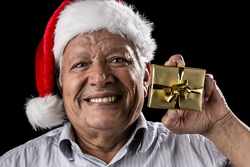 Image showing Old Gentleman With Red Hat Offering Golden Gift