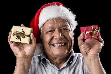 Image showing Smiling Aged Man Holding Two Small Xmas Gifts