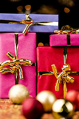 Image showing Four Solid Gift Boxes and Festive Spheres