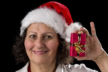 Image showing Venerable Woman with Red Cap Holding Small Gift