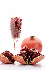 Image showing Pomegranate seeds and a whole pomegranate