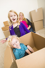 Image showing Young Family In Empty Room Playing With Moving Boxes