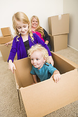 Image showing Young Family In Empty Room Playing With Moving Boxes