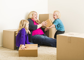 Image showing Young Family In Empty Room Playing With Moving Boxes