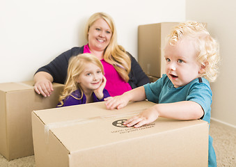 Image showing Young Family In Empty Room Playing With Moving Boxes