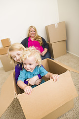 Image showing Young Family In Empty Room Playing With Moving Boxes