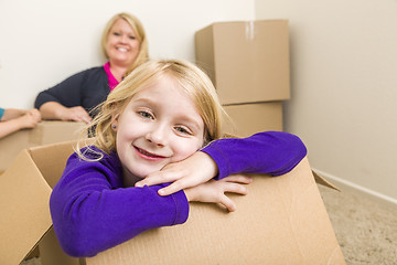 Image showing Young Mother and Daughter Having Fun With Moving Boxes