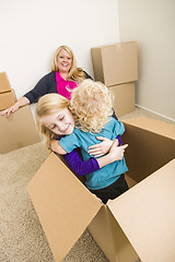 Image showing Young Family In Empty Room Playing With Moving Boxes