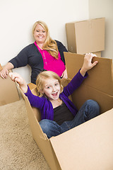 Image showing Young Family In Empty Room Playing With Moving Boxes