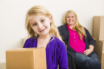 Image showing Young Mother and Daughter In Empty Room With Moving Boxes