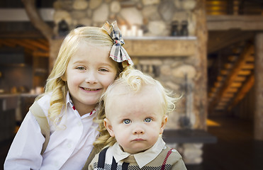 Image showing Cute Brother and Sister Pose In Rustic Cabin