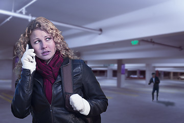 Image showing Frightened Young Woman On Cell Phone in Parking Structure