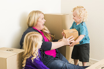 Image showing Young Family In Empty Room Playing With Moving Boxes