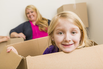 Image showing Young Mother and Daughter Having Fun With Moving Boxes