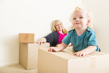 Image showing Happy Mother and Son in Empty Room with Moving Boxes