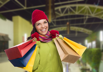 Image showing Warmly Dressed Mixed Race Woman with Shopping Bags