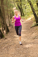 Image showing Pretty young girl runner in the forest. 