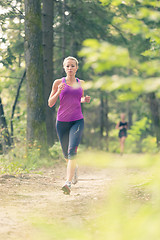 Image showing Pretty young girl runner in the forest. 