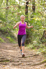 Image showing Pretty young girl runner in the forest. 