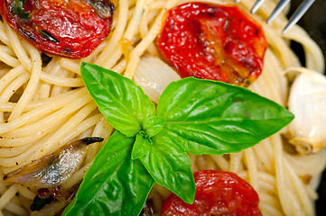 Image showing spaghetti pasta with baked cherry tomatoes and basil 