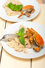 Image showing Italian gnocchi with seafood sauce with crab and basil