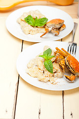 Image showing Italian gnocchi with seafood sauce with crab and basil