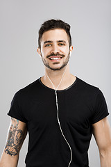 Image showing Man smiling and listen music